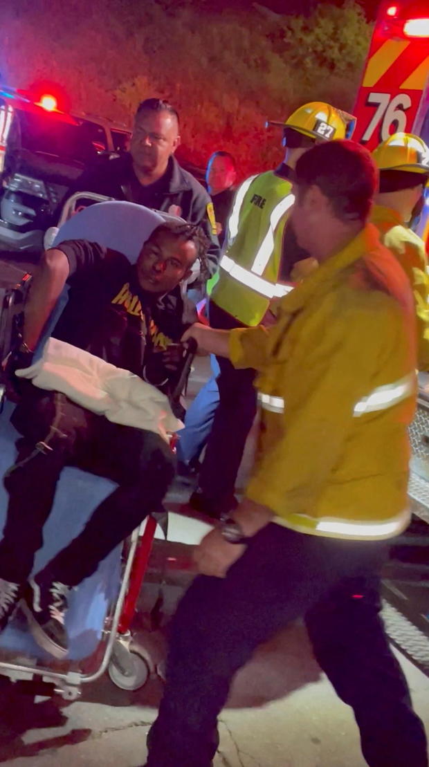 A man is transported to an ambulance after comedian Dave Chappelle was attacked onstage in Los Angeles 